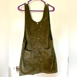 Sage Green corduroy button down sleeve less dress with pockets.